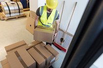 warehouse worker lifting boxes