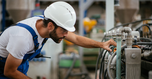 man wearing hard hat in mechanical plant room