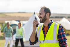 male volunteer on walkie talkie at outdoor event