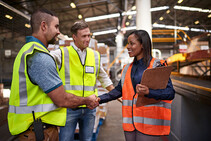 friendly workers greeting each other in warehouse