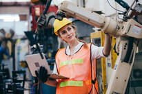 Female industrial engineer or technician worker in hard helmet.