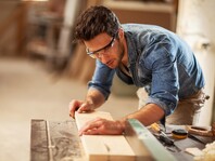 Joiner sawing wood