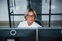 female worker at workstation working with display screen equipment