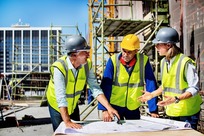 workers in PPE on construction site