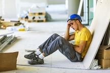 stressed male construction worker on site