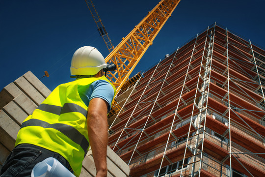 Construction engineer supervising building process