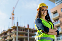 young female construction worker on site wearing PPE