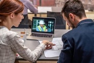 workers at a desk, participating in online webinar