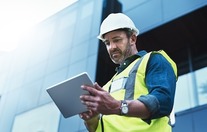 construction worker on site with clipboard