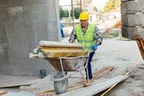 construction worker moving material on site