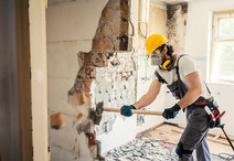 worker using hammer in demolition work