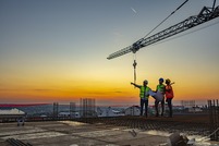 workers on roof of high-rise construction site