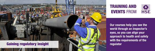 Image of a HSE inspector taking a photo of a metal pipe on a construction site as part of an inspection