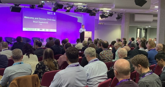 Speaker on stage at a HSE Conference 