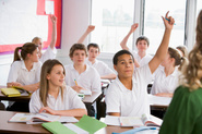 [Stock image] pupils in class hands up