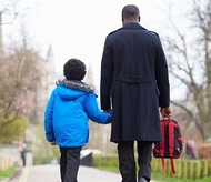 [Stock image] father and son walking to school