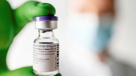 Doctor holding vile of vaccine 