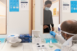 Image of a staff member helping with the rapid testing roll out