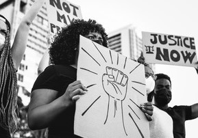 woman holding sign at a racial justice protest