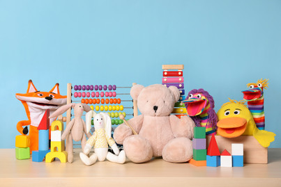 A range of different toys in all shapes, colours and sizes on a table