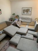 Child stretching between two sofas