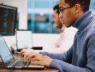 Image of a person working on a laptop