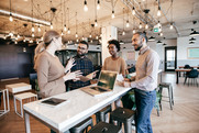 Image of two people working at a laptop