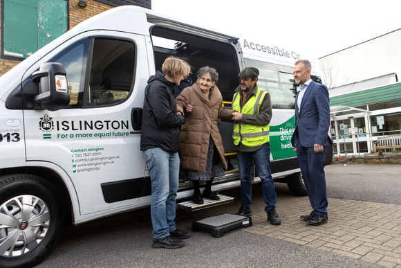 A resident is helped off the bus by Cllr Champion and Keith Townsend, Islington's Corporate Director for Environment and Climate Change