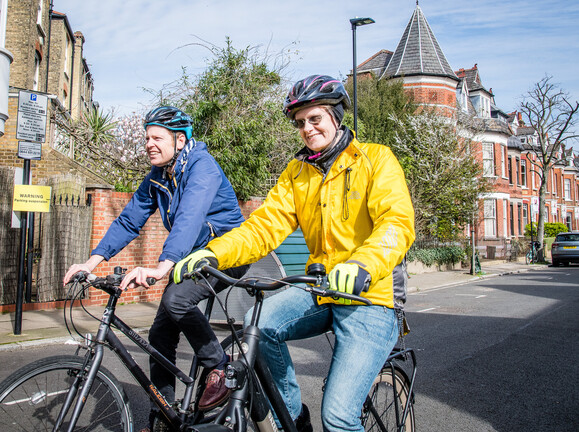 Cllr Rowena Champion and Bart Smith, Islington Council's Active Travel Officer, cycle near one of the borough's bike hangar