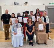 A group of parent champions holding up their certificates