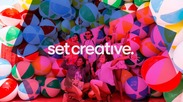 Set Creative Image of people standing in front of colourful baloons