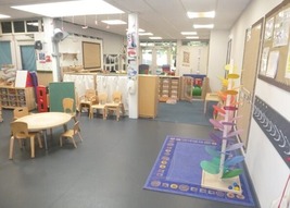 A nursery room with small tables and chairs