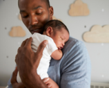 A parent holding a baby