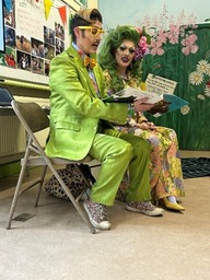 Two drag artists reading a story