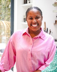 A woman smiling and looking directly at the camera