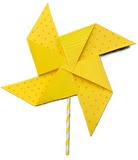 paper pinwheel made of bright yellow paper and a paper straw