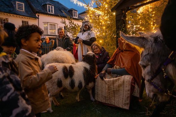 christmas nativity scene with children petting live goats