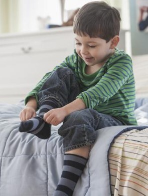 child putting sock on