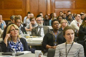 staff sitting in assembly hall 