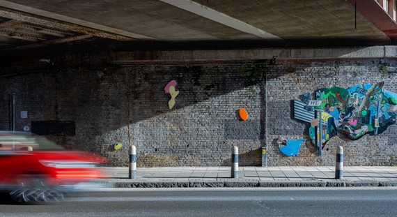 Painting by Flo Brooks under railway bridge in Clapham