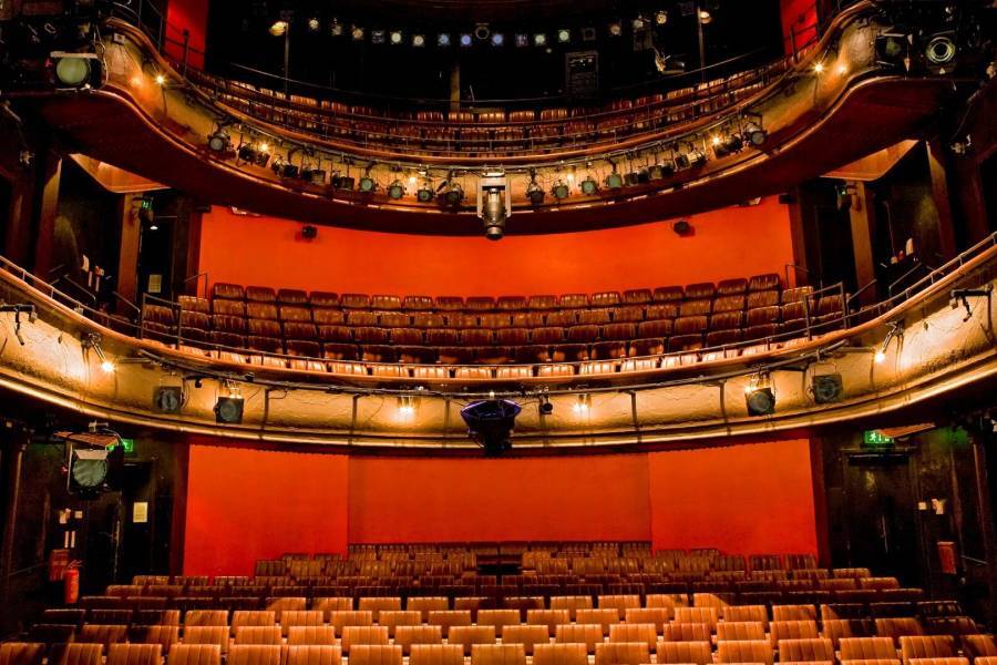 The inside of royal court theatre with red seats 