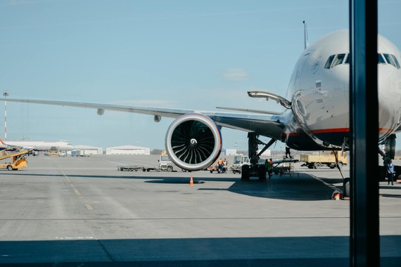 Airplane being boarded at an airport.