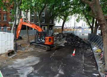 View of work on Princes Circus with a digger moving materials and a large pile of rubble