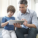 man and boy with ipad