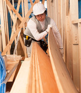 Man using plywood on building site