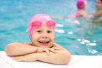 Young girl on side of swimming pool