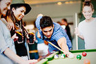 teenagers playing pool