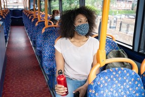 Girl on bus with face mask