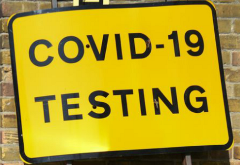 COVID testing yellow sign