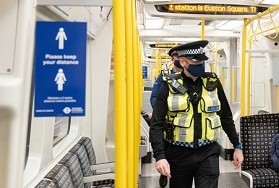 Enforcement officers on tube train
